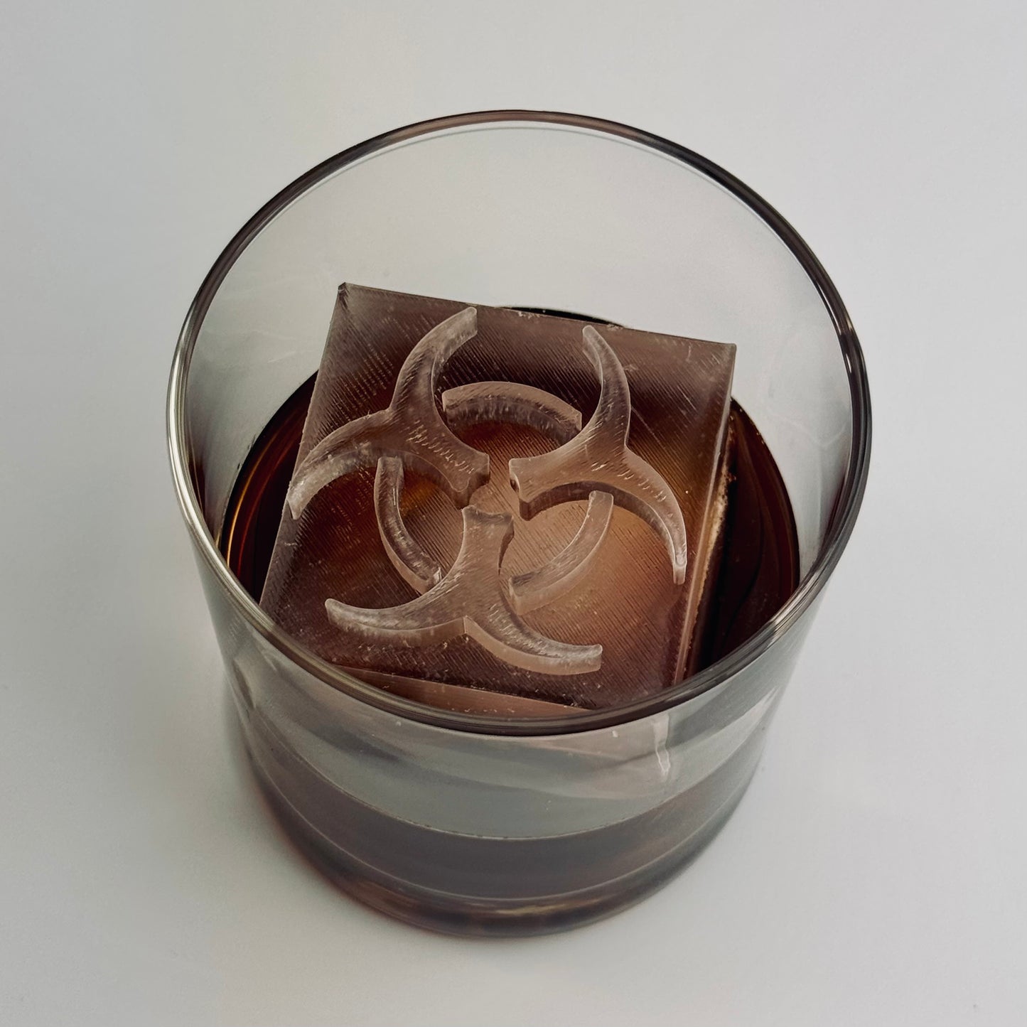 Zombie-themed cocktail featuring biohazard ice cube