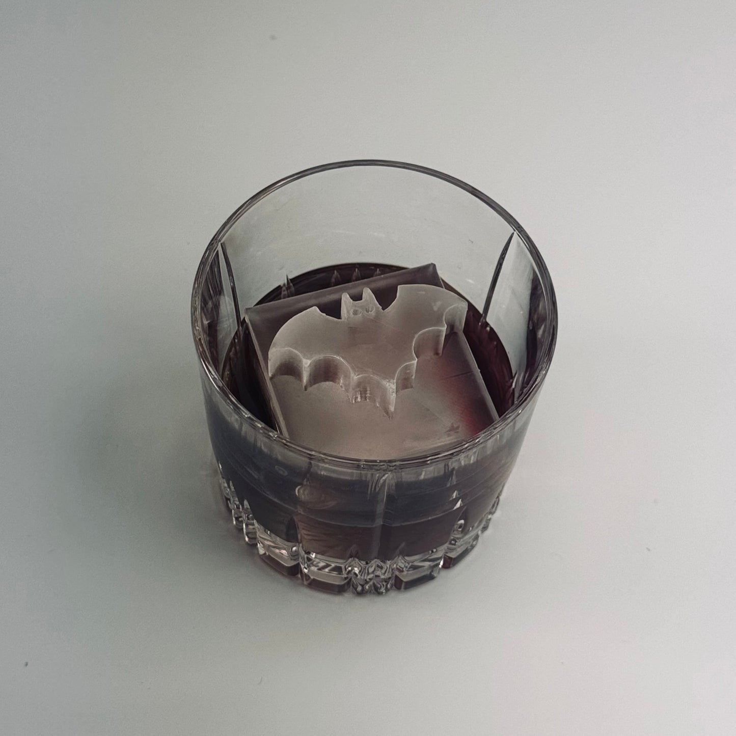 Glass with a Batman logo on a white background