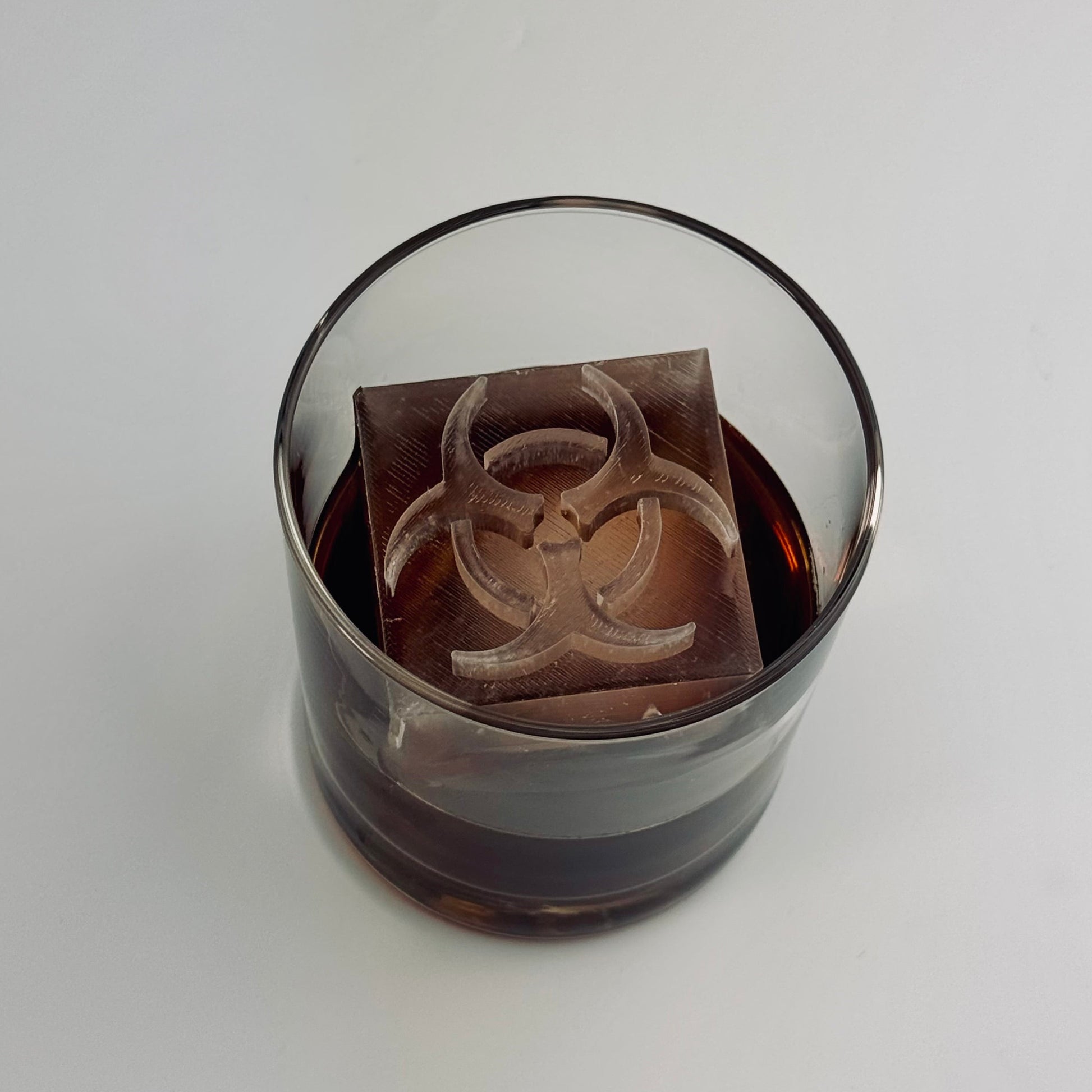 Biohazard ice cube close-up with raised symbol design