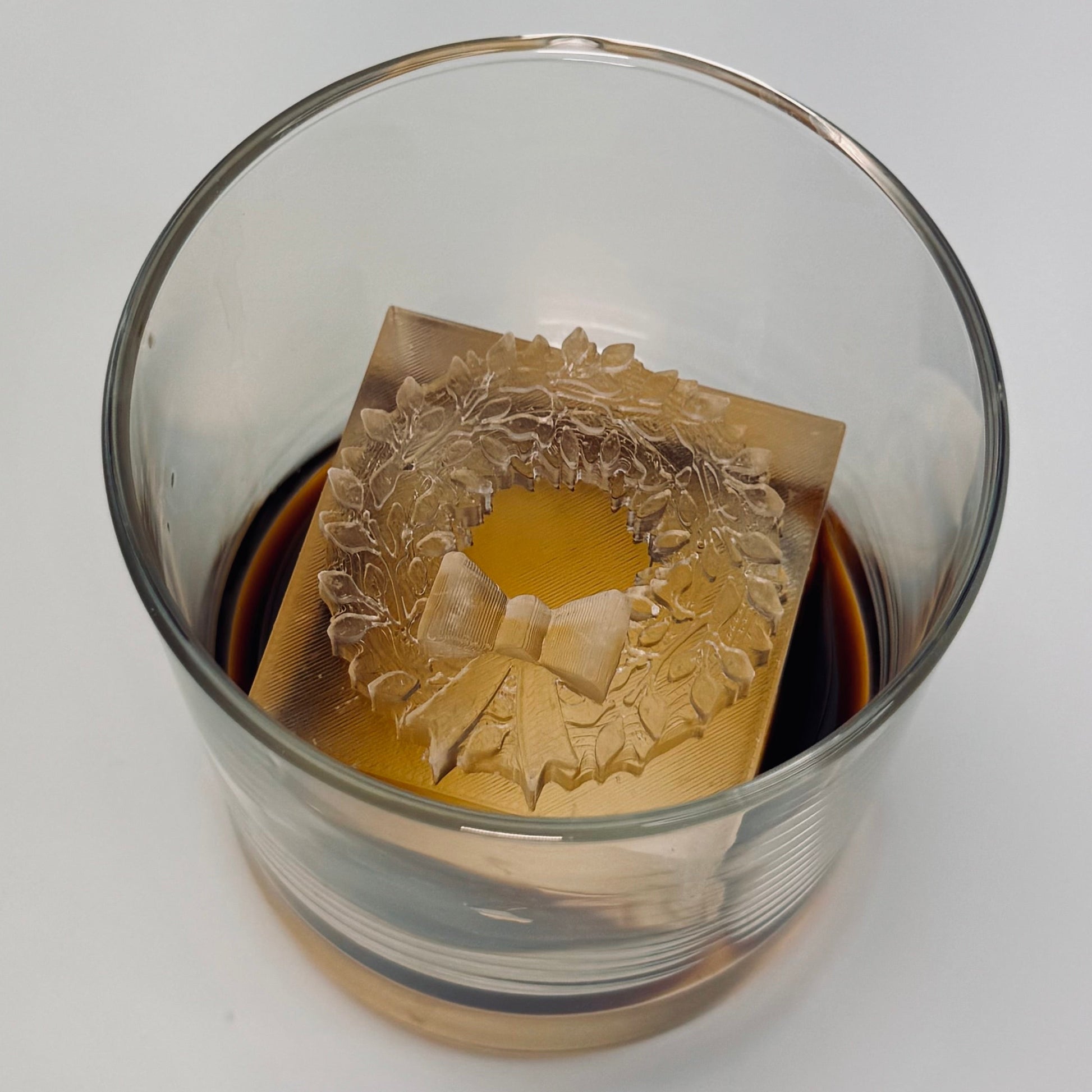 glass with clear ice cube with Christmas Wreath on it 