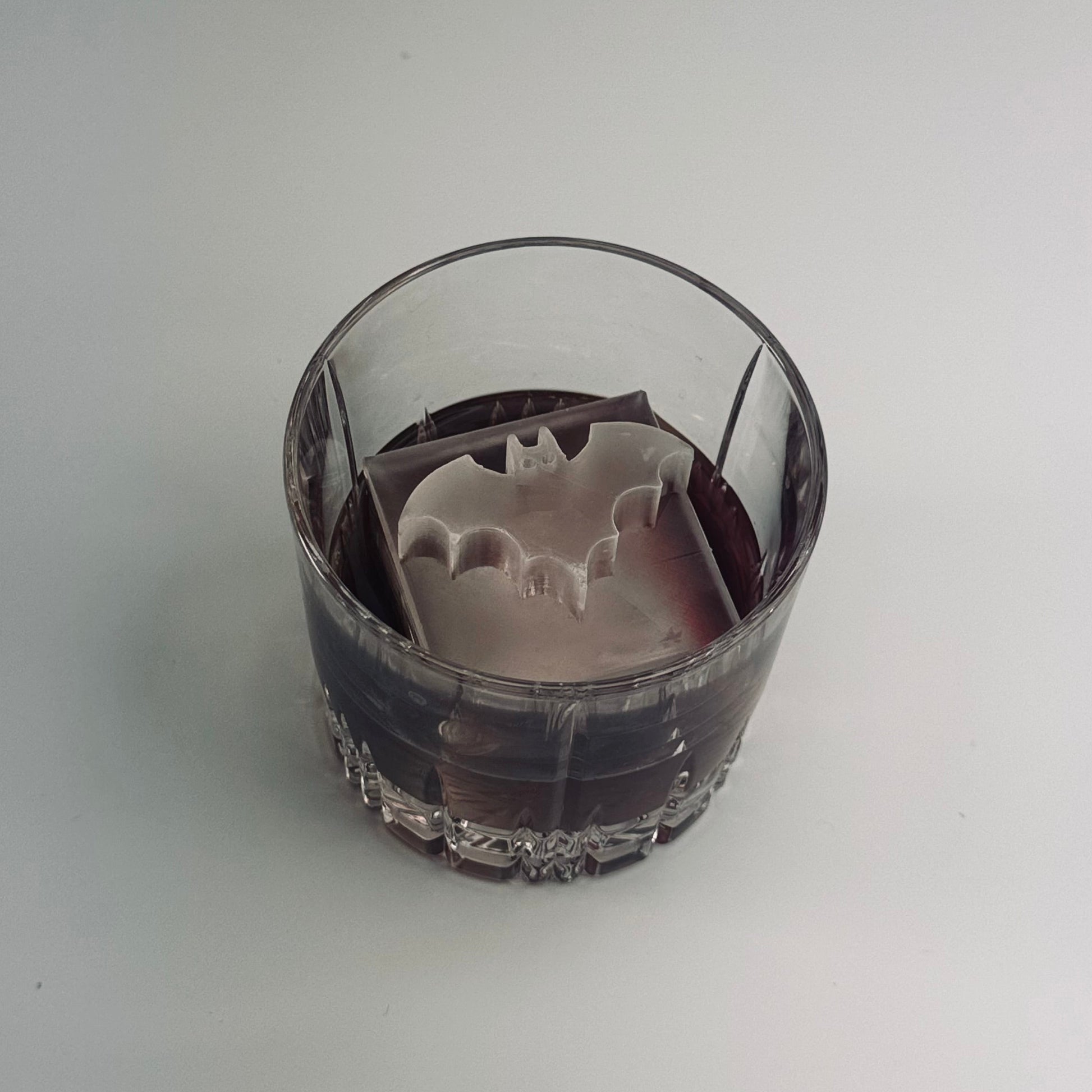 Glass with a Batman logo on a white background