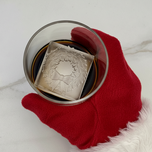 Santa Claus Hand grabbing glass with Christmas wreath ice cube