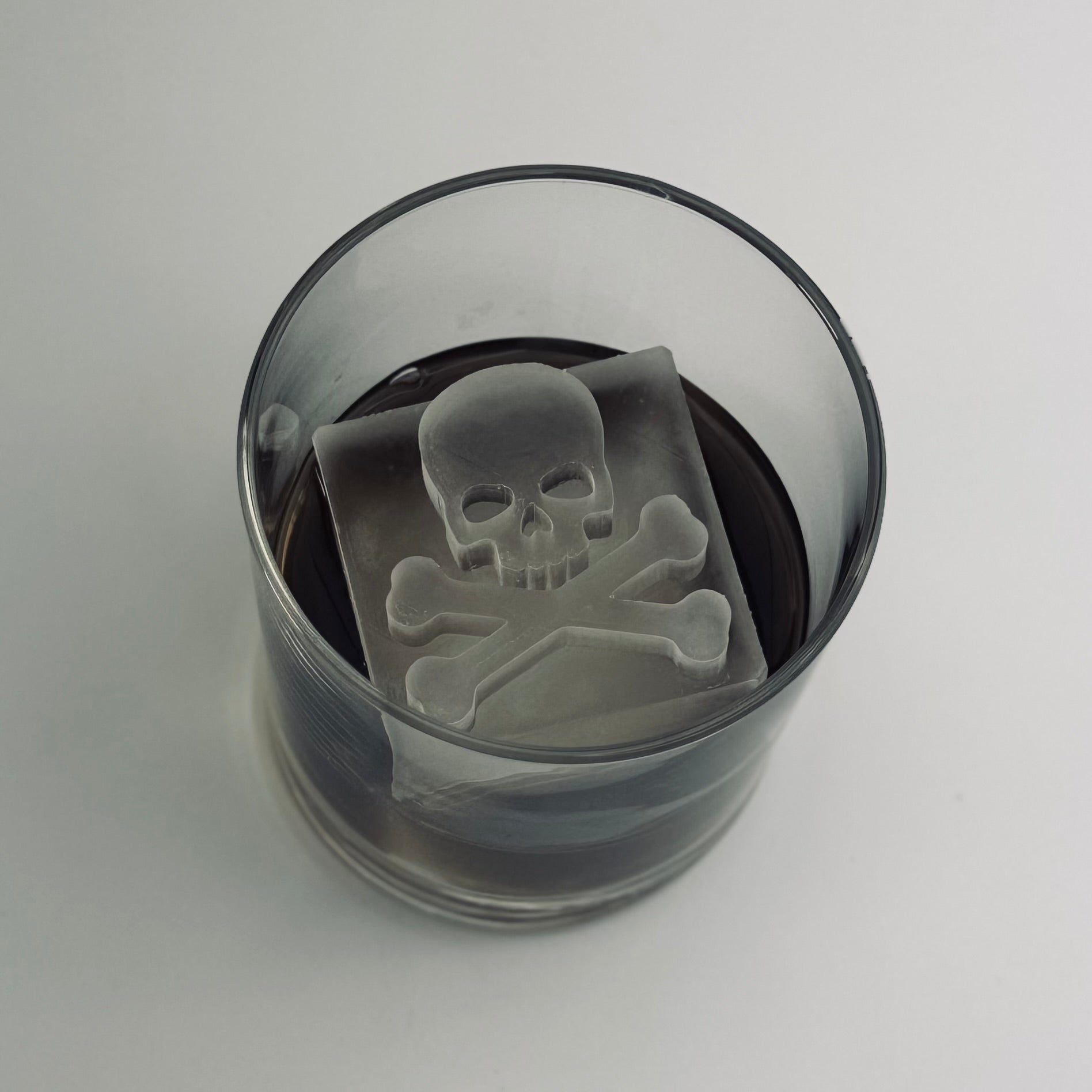 Glass with a skull and crossbones design on a white background