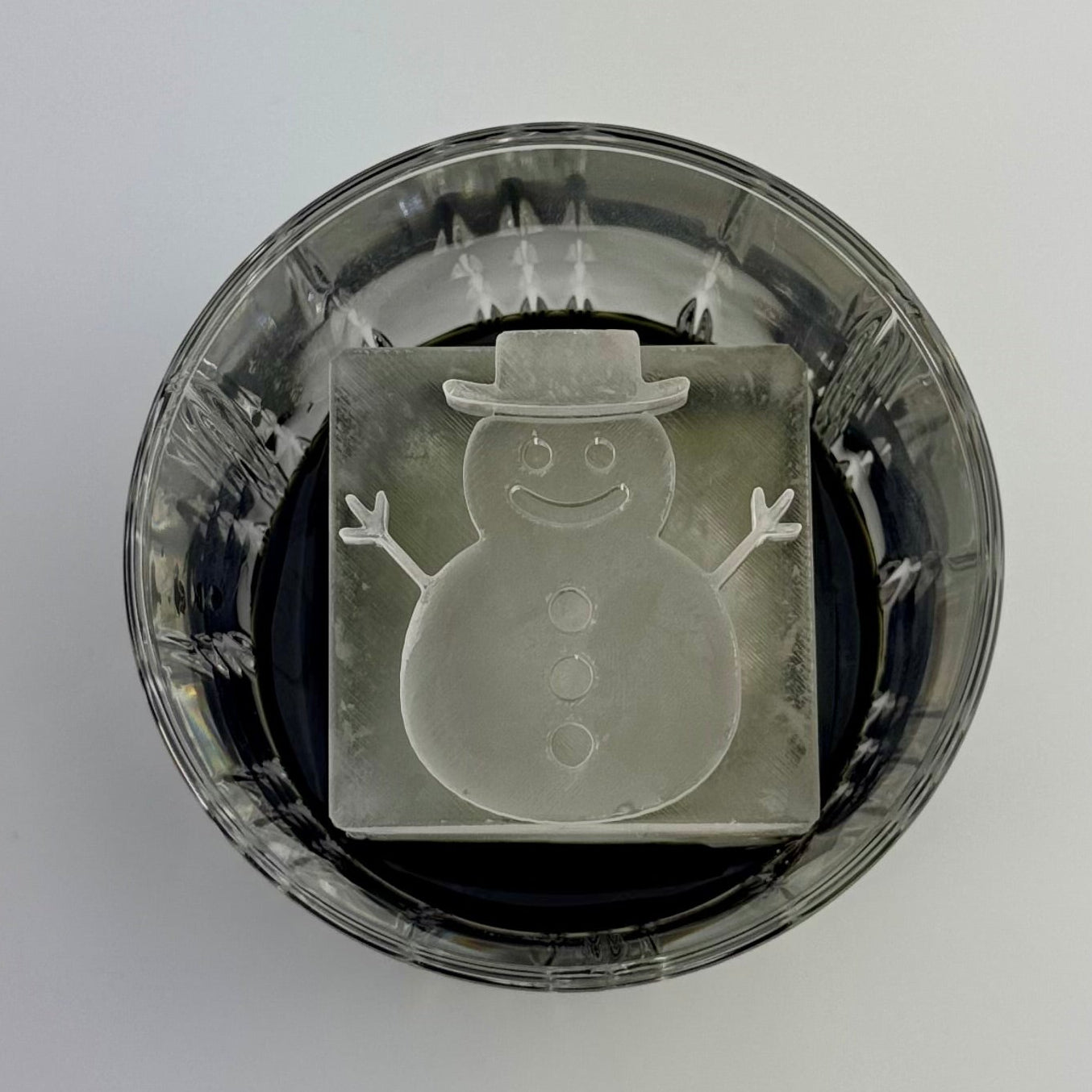 Ice snowman-shaped object on a white background